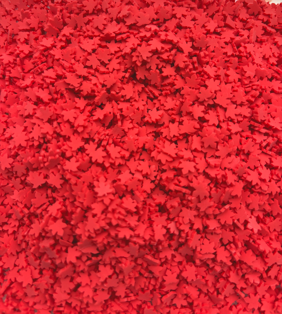 a large pile of red star shaped confetti
