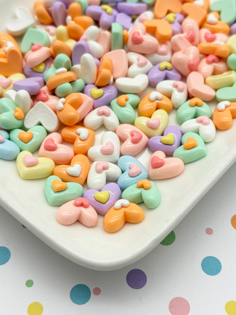 a white plate topped with lots of candy hearts