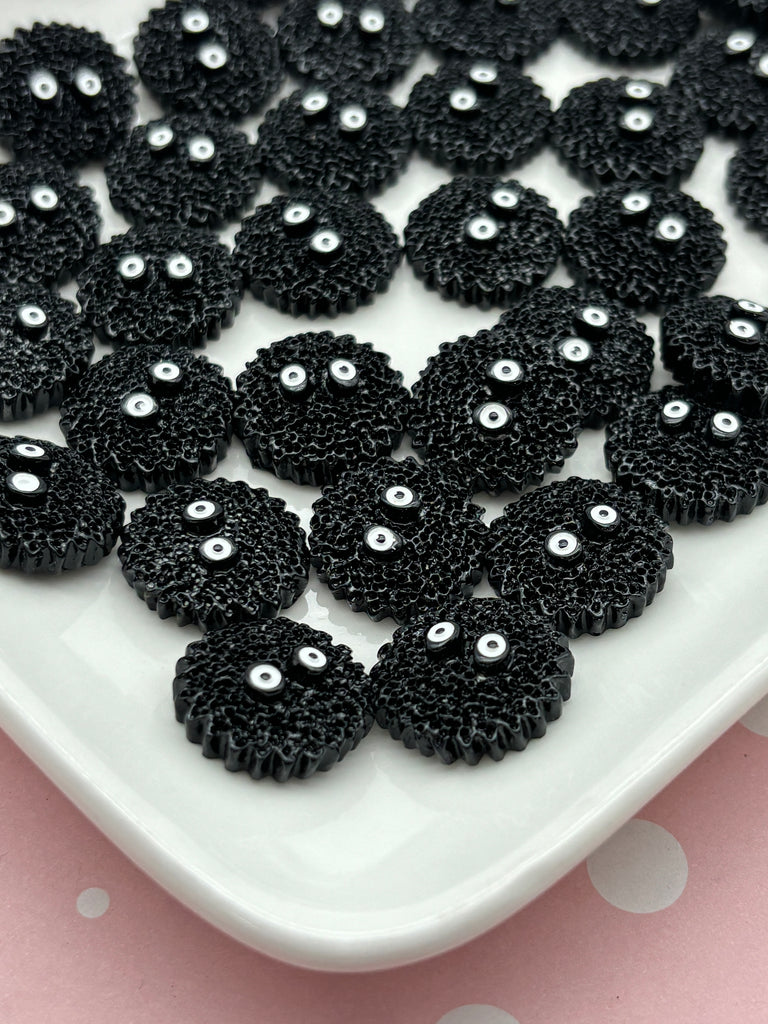 a white plate topped with lots of black beads