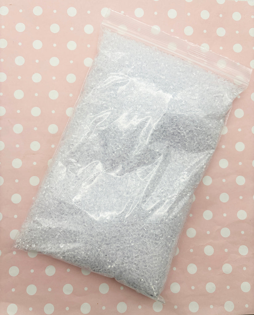 a plastic bag filled with white dots on a pink surface