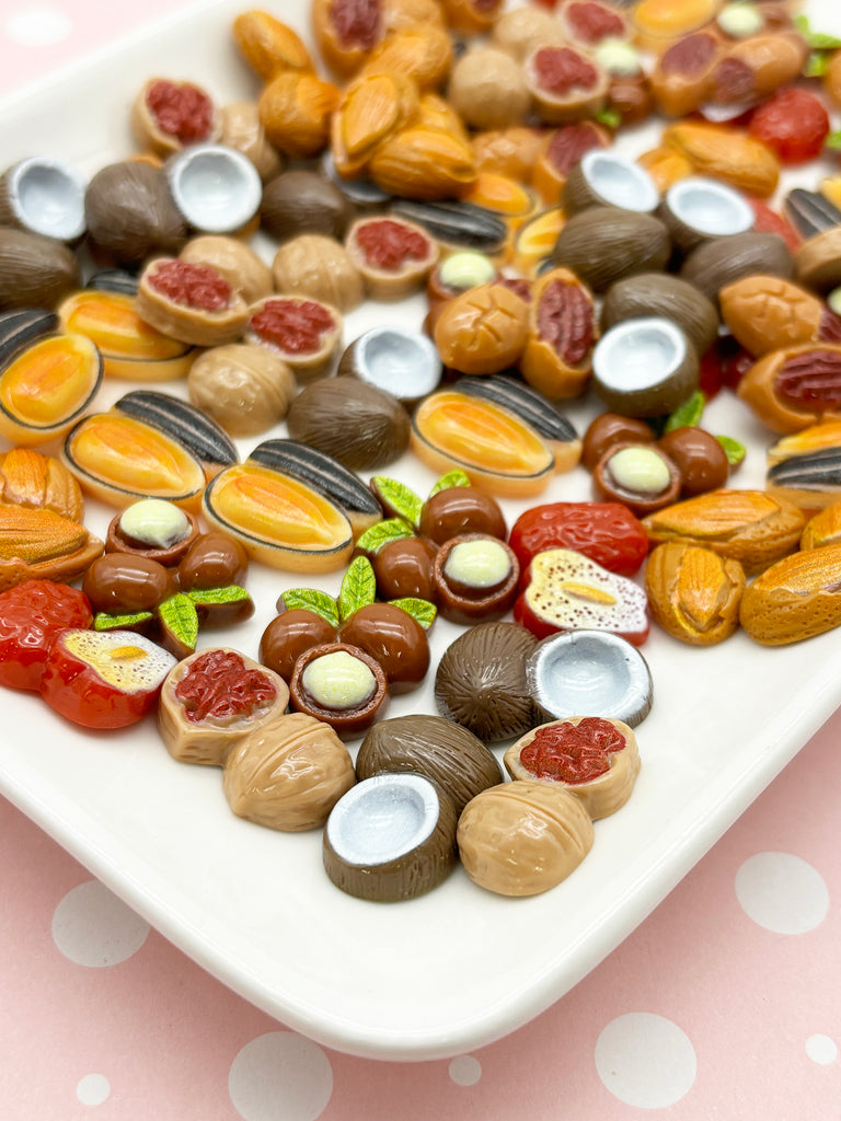 a white plate topped with assorted nuts on top of a table