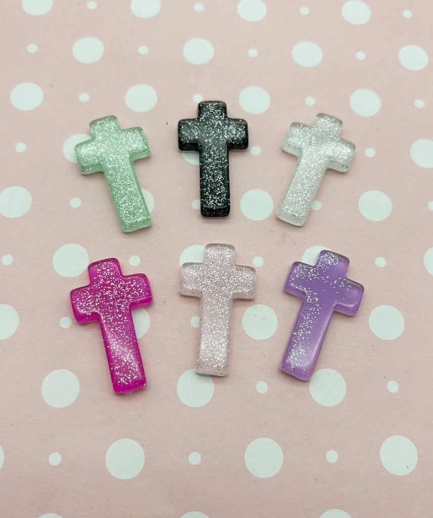 a group of small plastic crosses sitting on top of a table