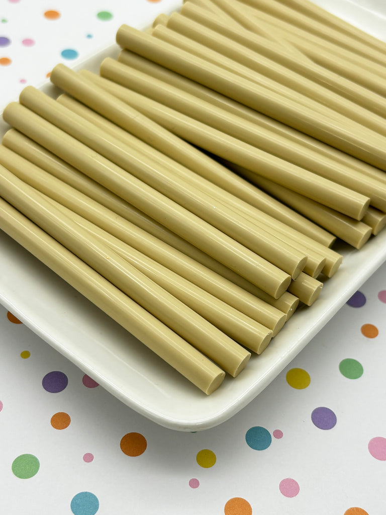 a white plate topped with lots of brown straws