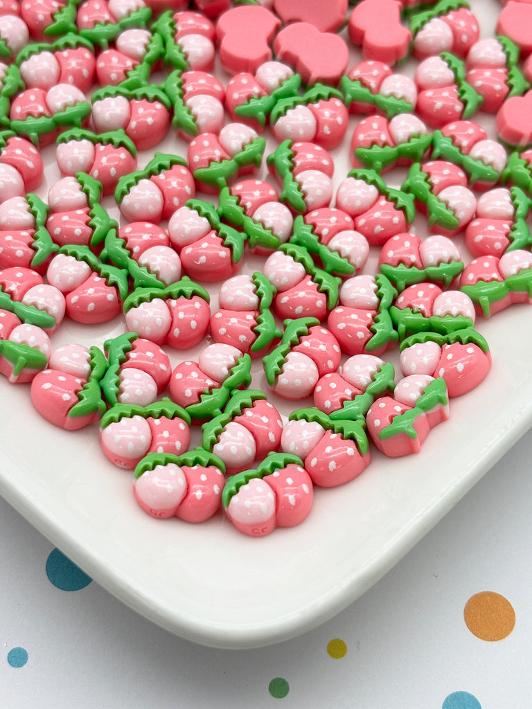 a white plate topped with lots of pink and green candies