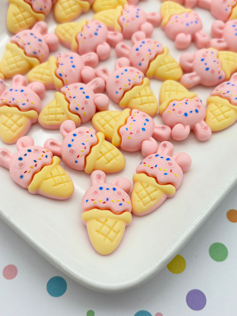 a white plate topped with lots of pink and yellow cookies
