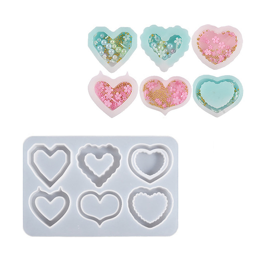 a set of heart shaped cookie cutters next to a cookie sheet