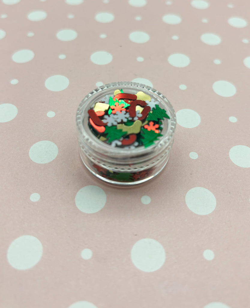 a small glass jar filled with confetti on top of a polka dot table