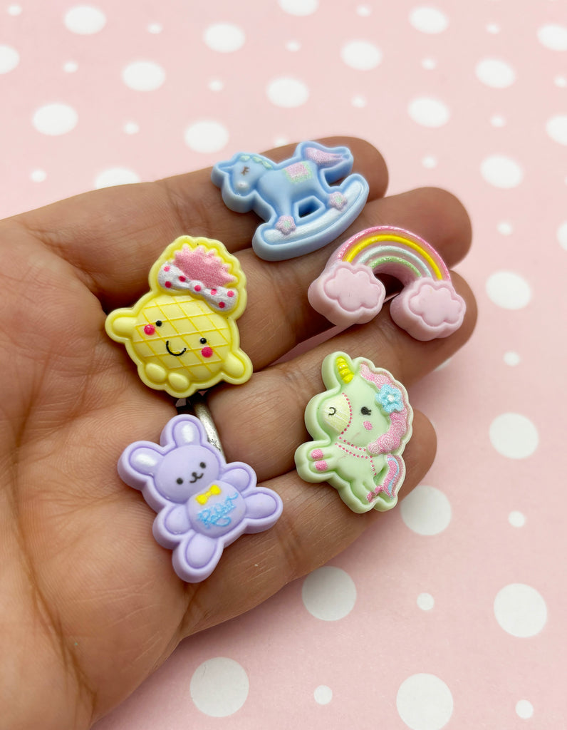 a person is holding a set of four small erasers
