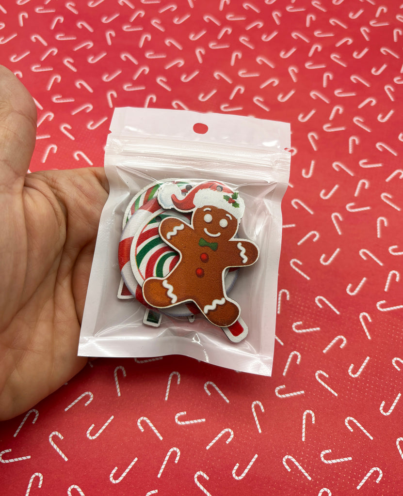 a hand holding a bag of christmas cookies