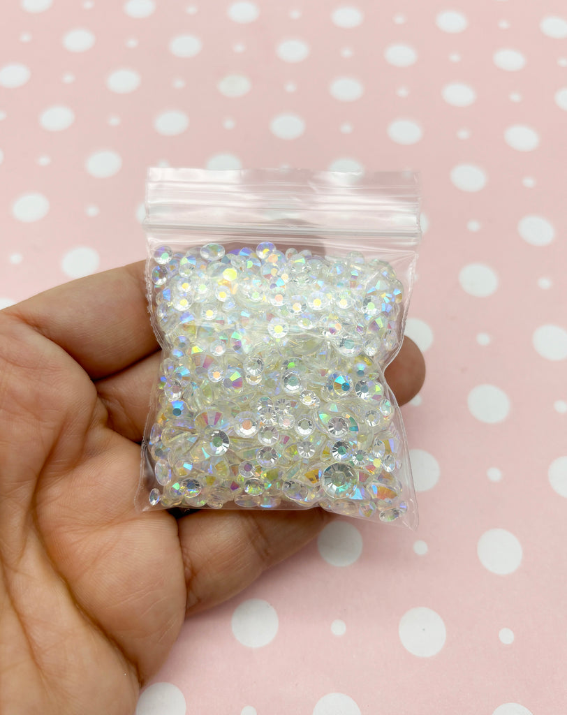 a hand holding a bag of white glitter