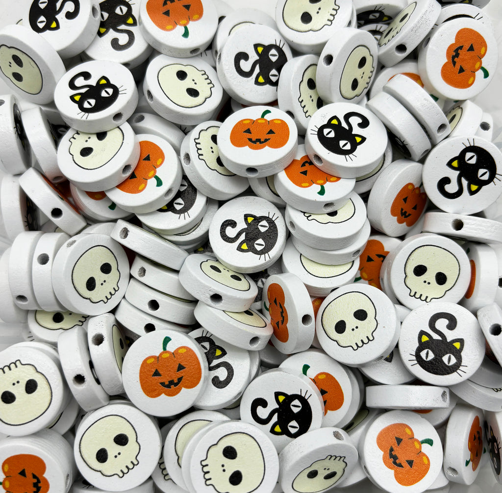 a pile of halloween themed headphones with faces on them
