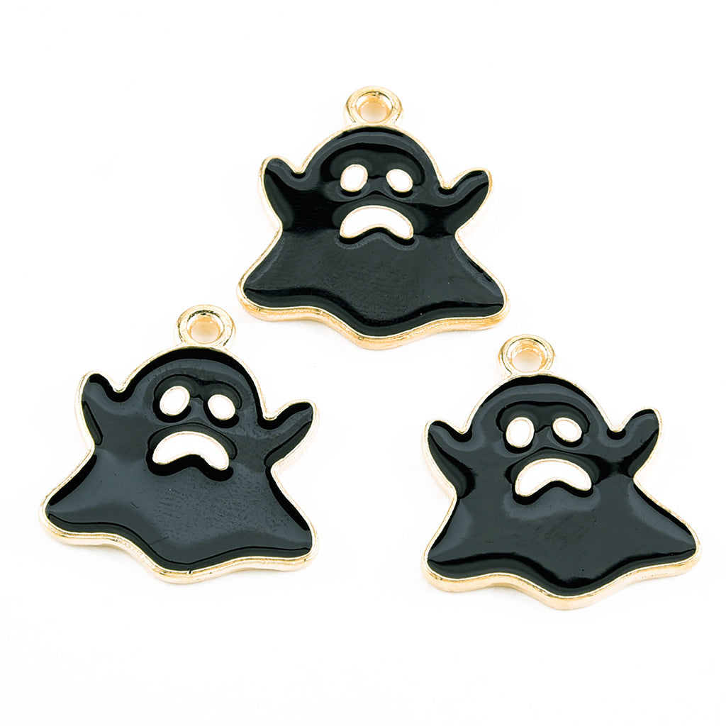 a set of three black and gold tone ghost charms