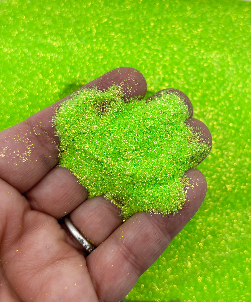 a hand holding a green substance in it's palm