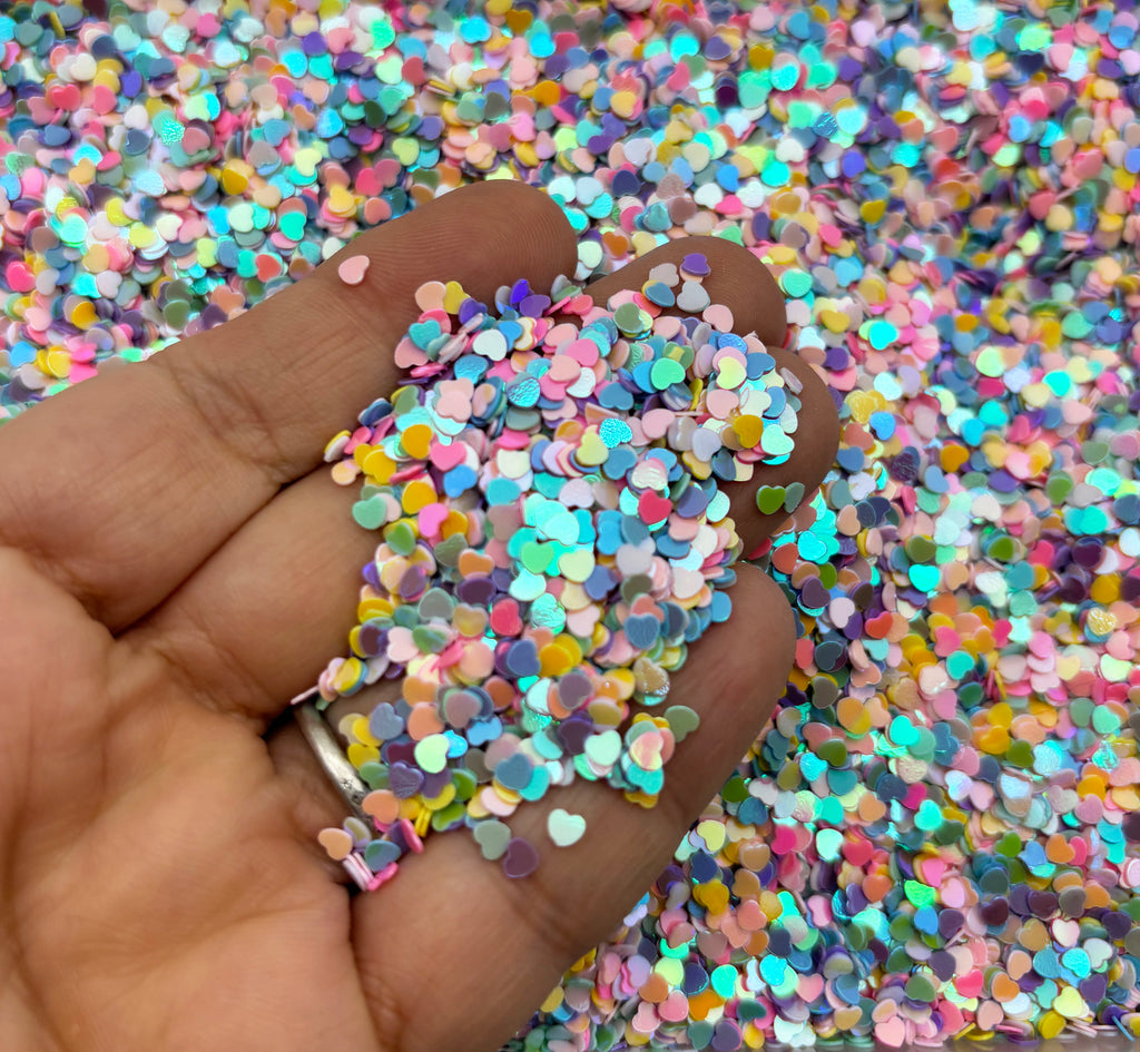 a hand holding a handful of colorful confetti