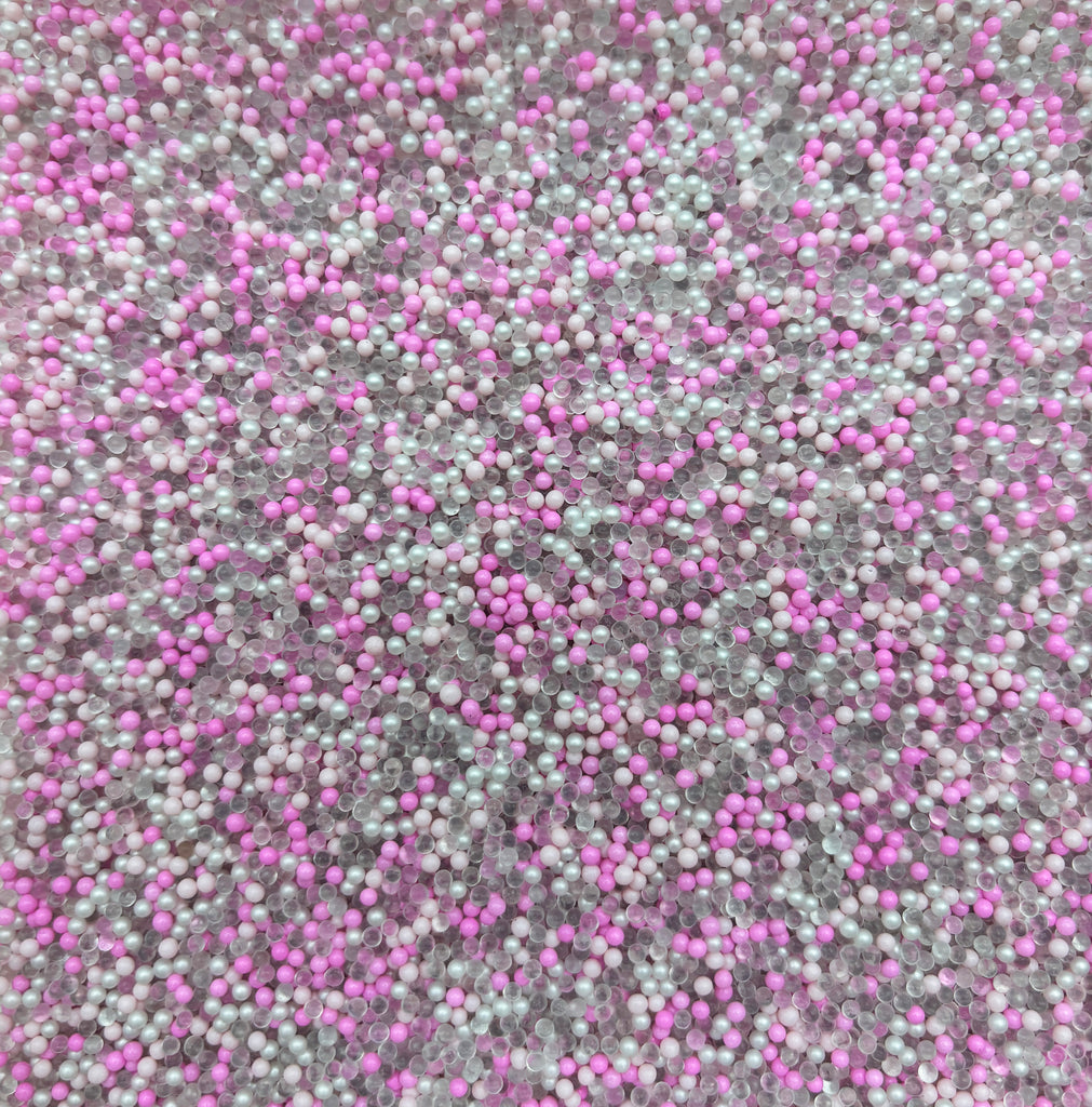 a close up view of a carpet with pink and grey speckles