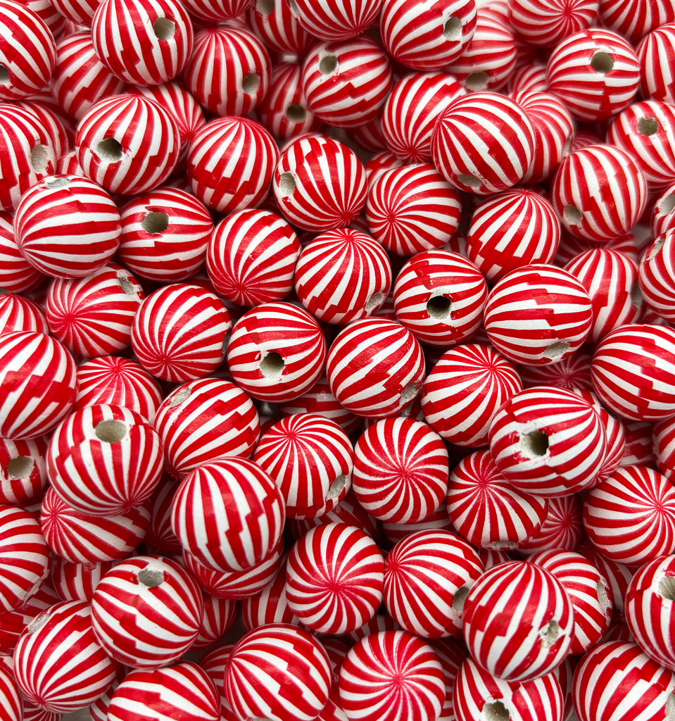 a pile of red and white striped balls