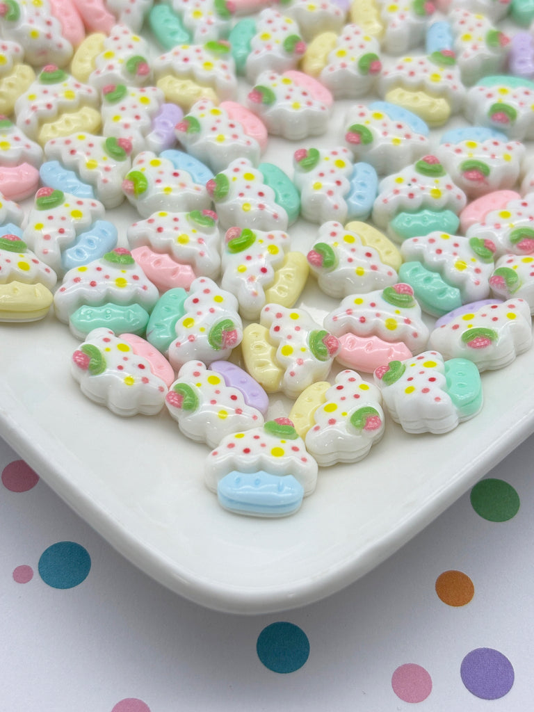 a white plate topped with lots of colorful cookies