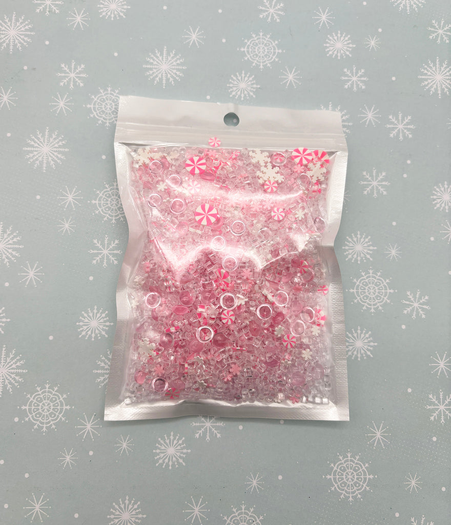 a bag of pink and white plastic beads