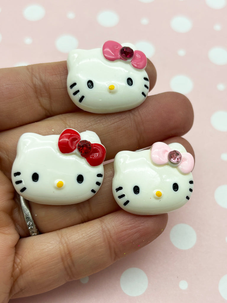 a person holding two hello kitty rings in their hand
