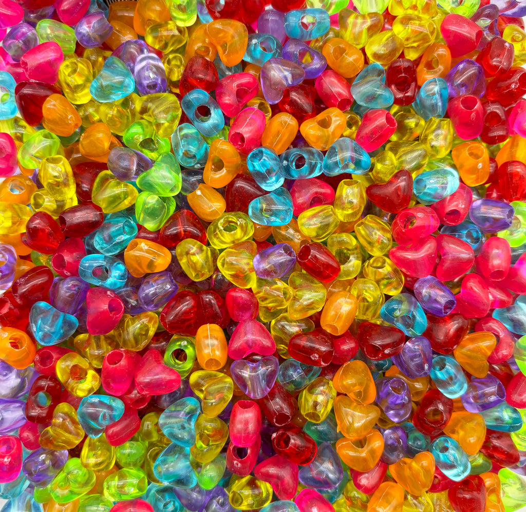 a pile of multicolored beads sitting on top of a table