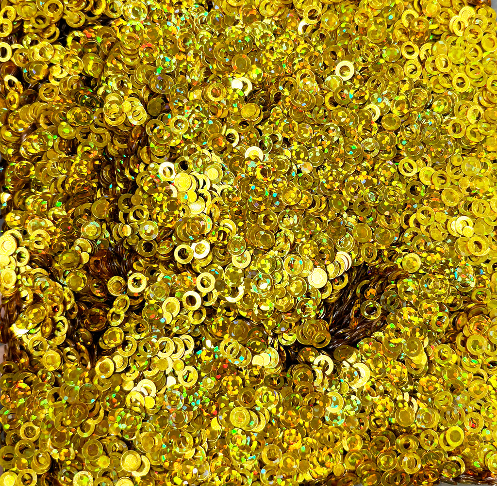 a large pile of gold colored sequins