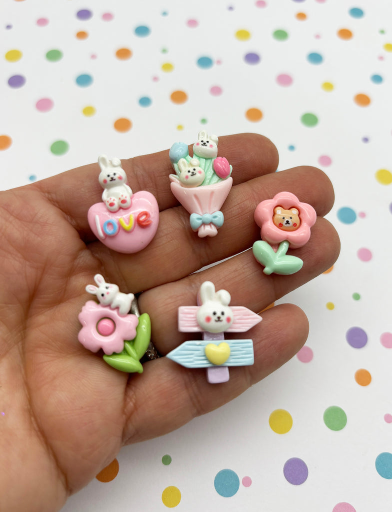 a person is holding a set of tiny toy animals