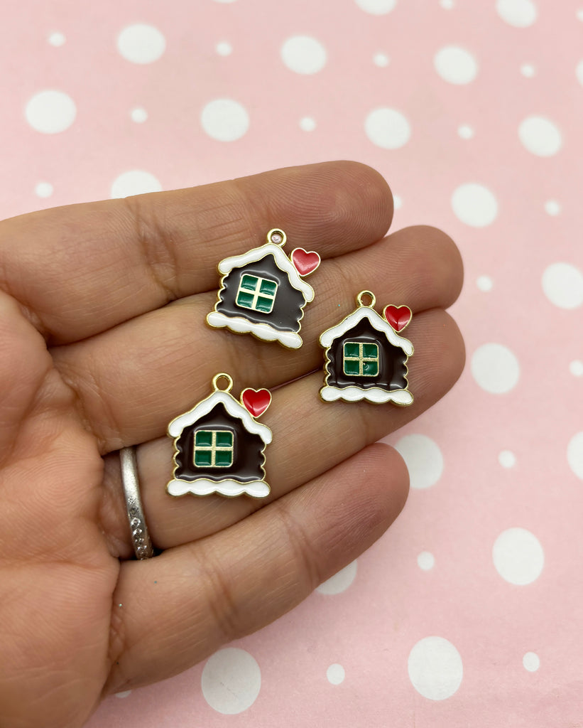 a person holding three small houses in their hands