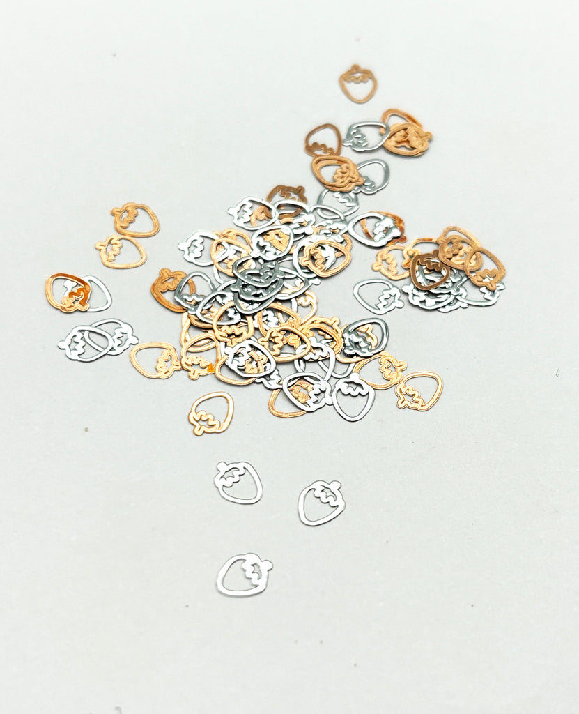 a pile of gold and silver rings on a white surface