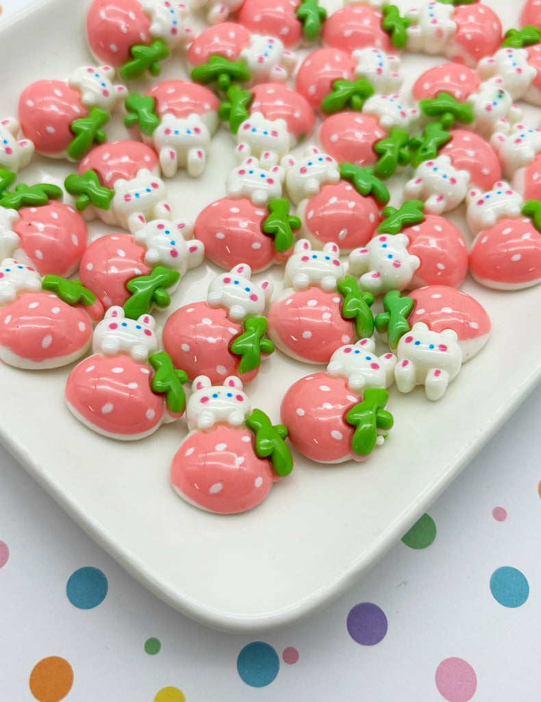a white plate topped with lots of pink and green cookies