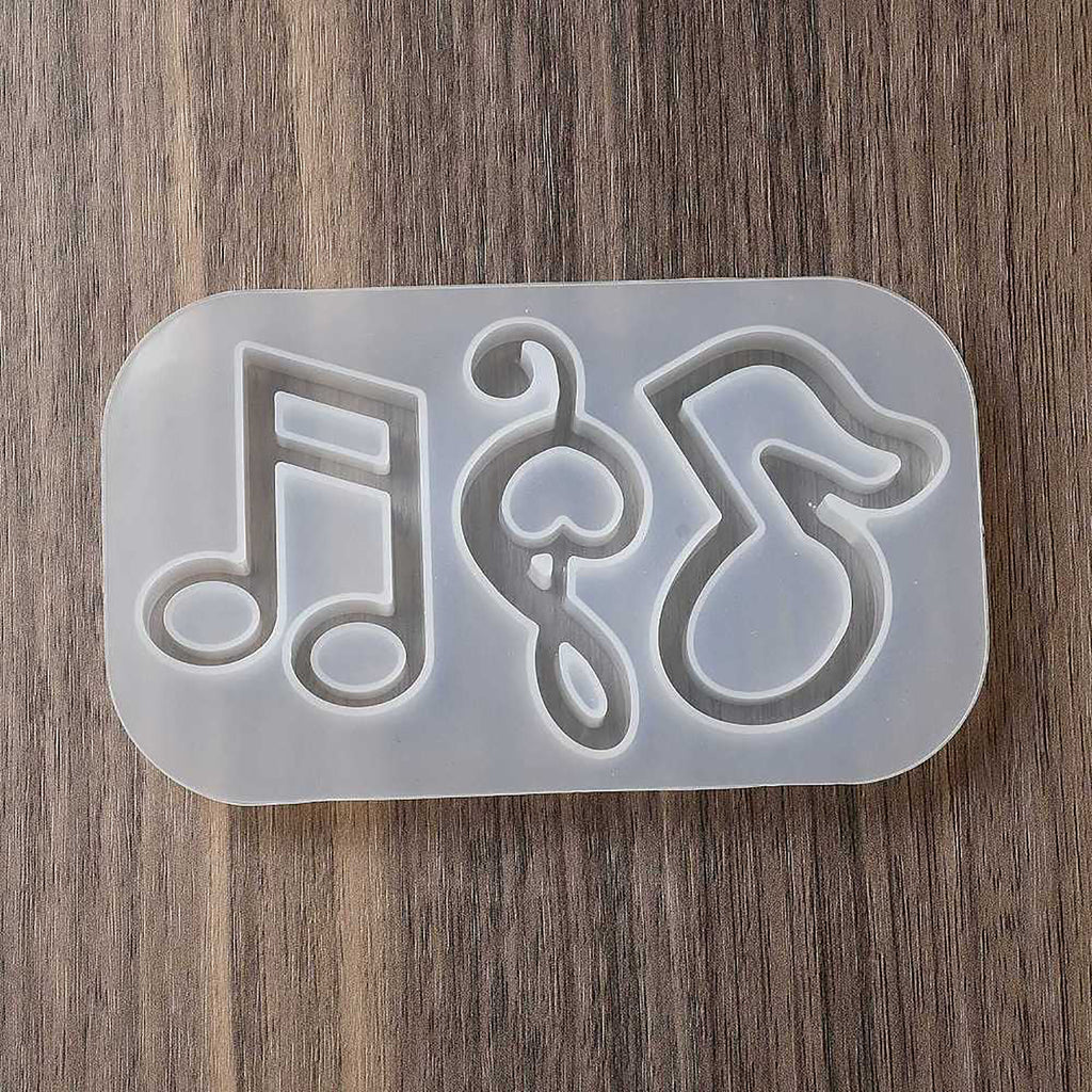 a cookie cutter with music notes and a treble