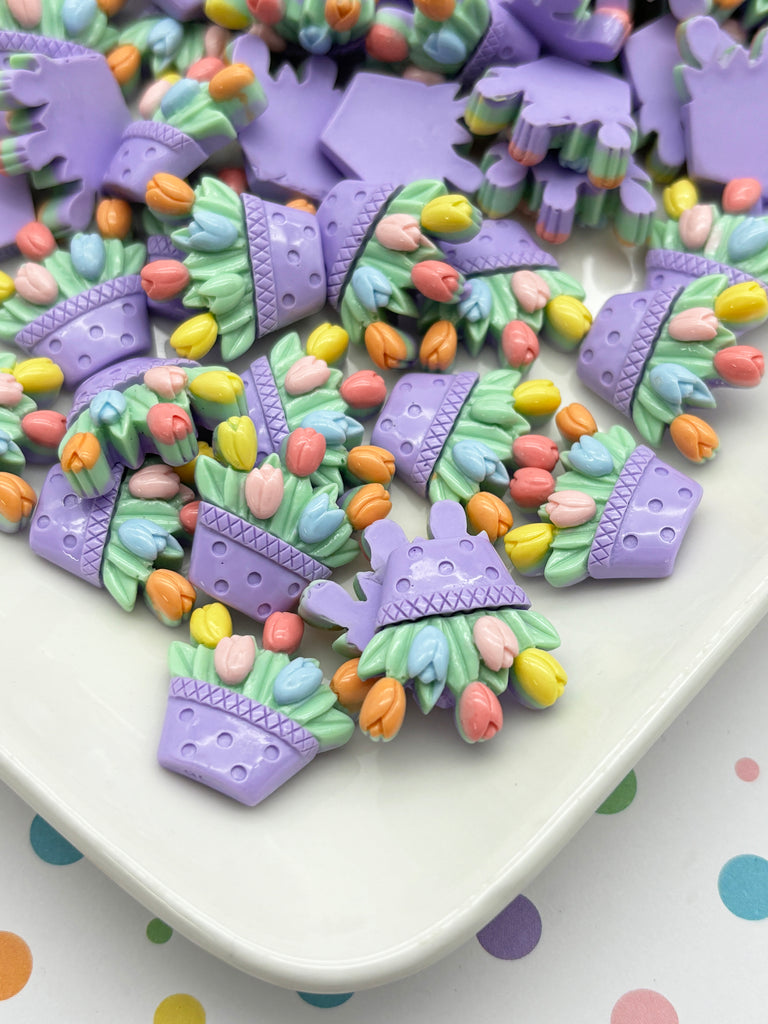 a white plate topped with lots of purple and green cookies