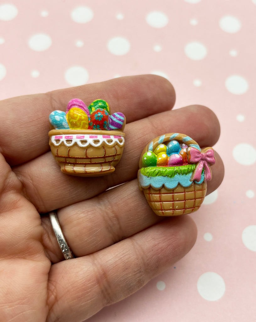 a person is holding two miniature baskets of candy