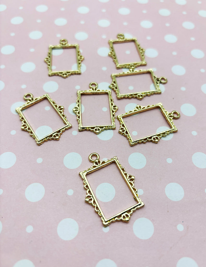 a group of small square charms sitting on top of a table