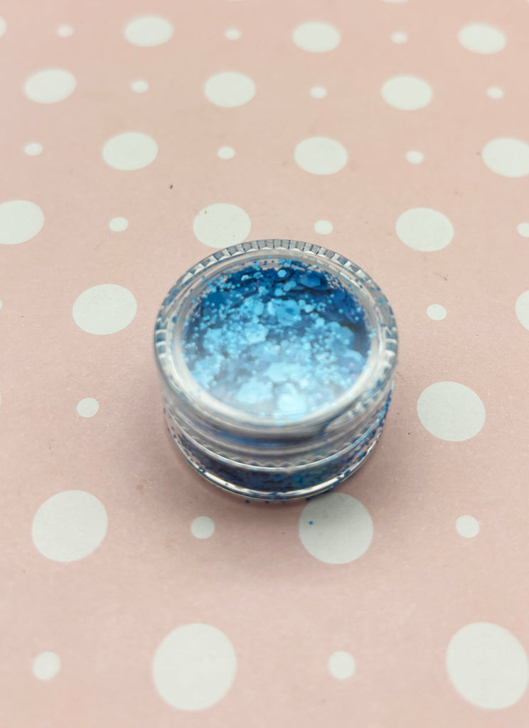 a close up of a blue and white container on a polka dot tablecloth