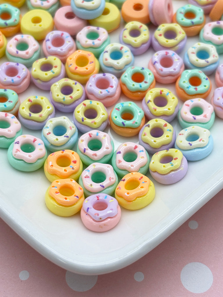 a white plate topped with lots of colorful donuts