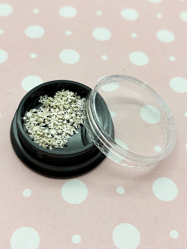 a black container with white sprinkles in it
