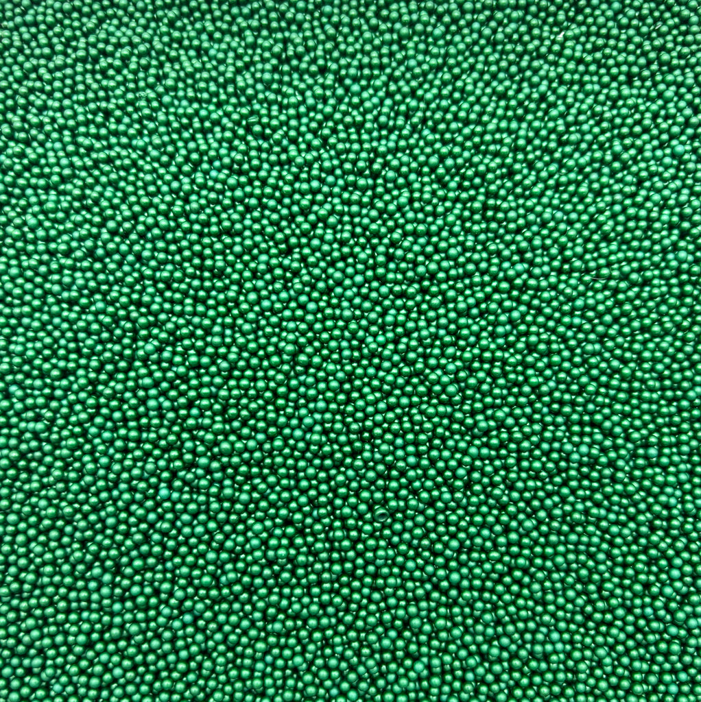 a close up of a green surface with small dots
