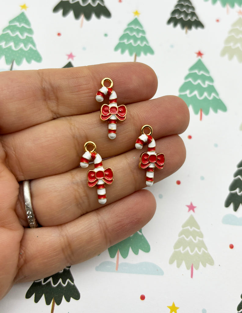 a pair of red and white candy cane charms