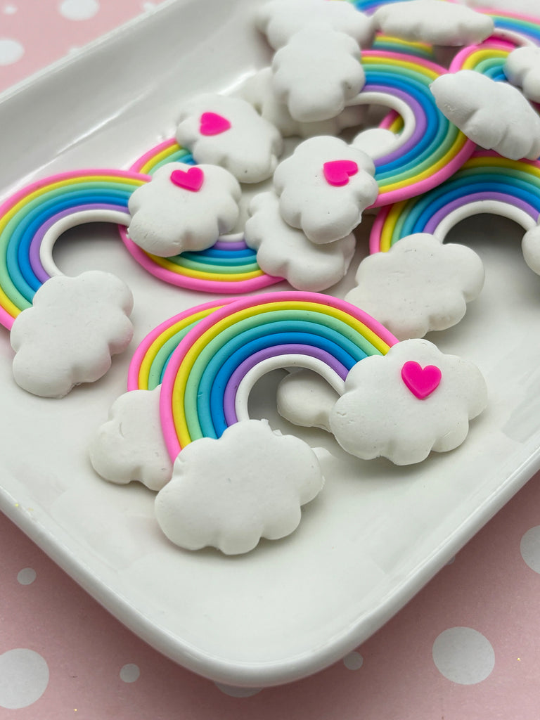 a white plate topped with rainbow cookies on top of a table