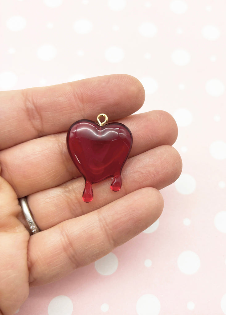 a person holding a heart shaped object in their hand