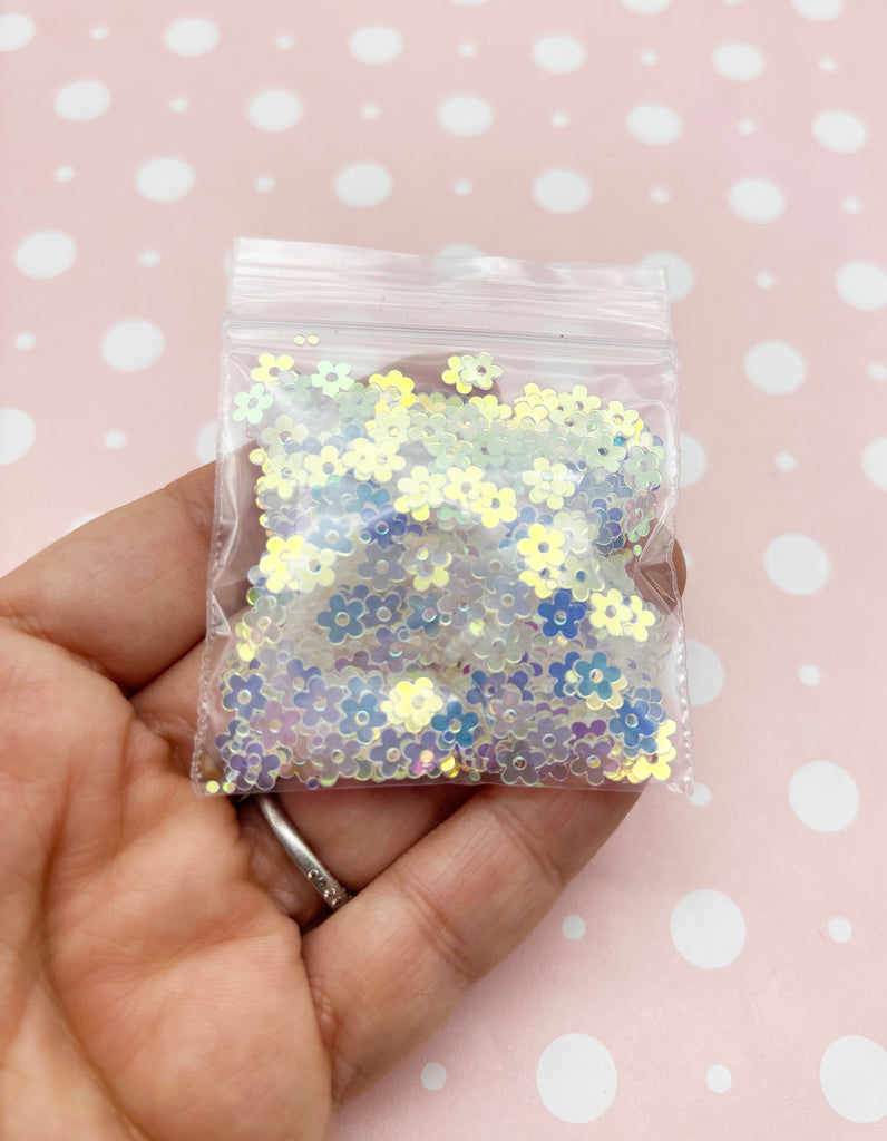 a person holding a bag of glitter in their hand