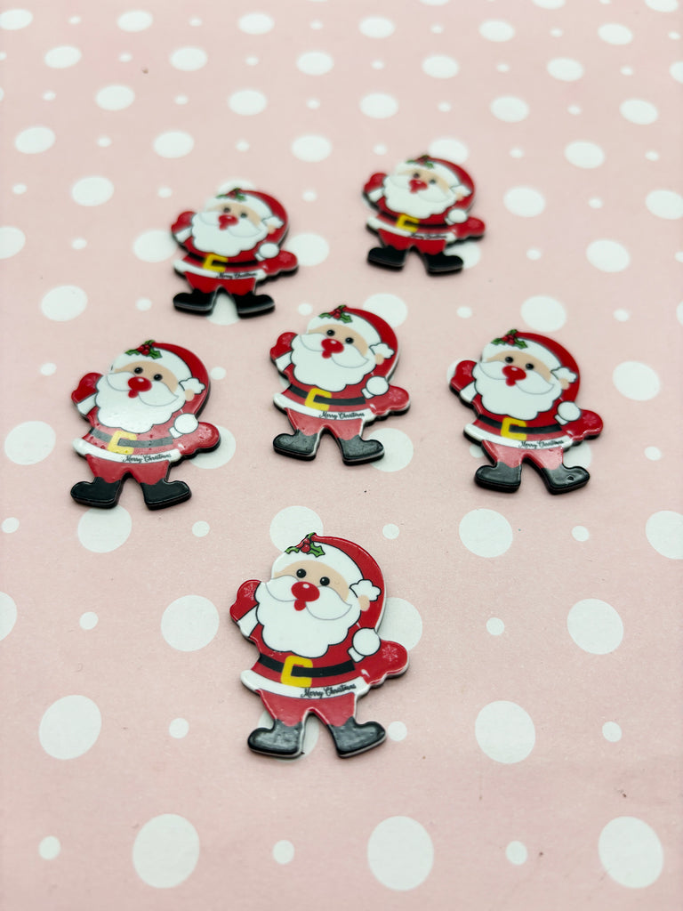 a group of santa claus buttons sitting on top of a table