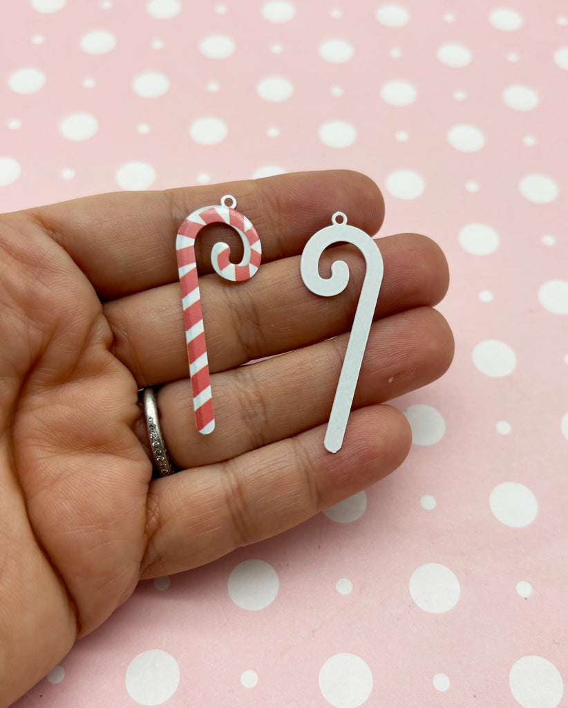 a person holding a candy cane in their hand