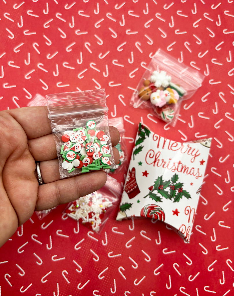 a hand holding a bag of christmas candy