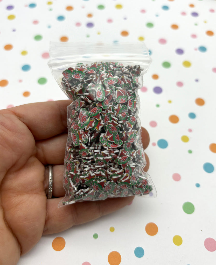 a hand holding a bag of sprinkles on a table