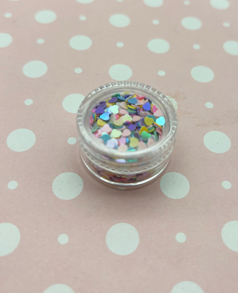 a small jar of confetti on a polka dot tablecloth
