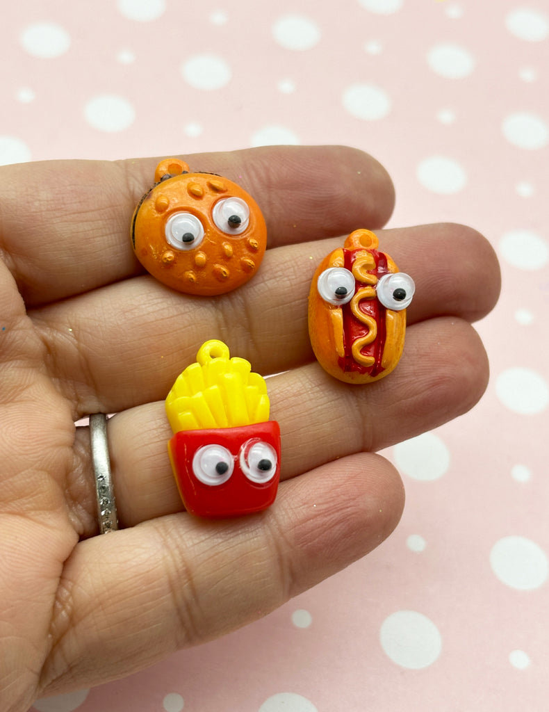 a person is holding three fake food rings