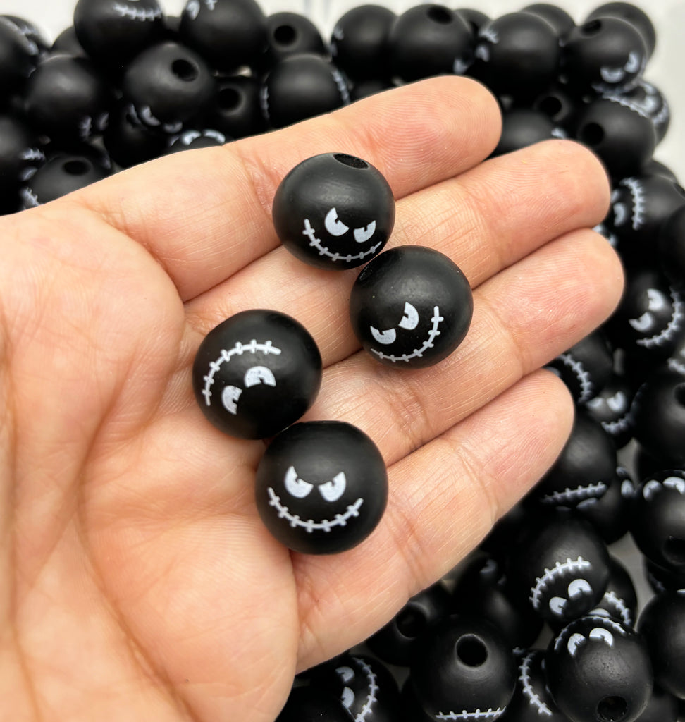 a hand holding a bunch of black beads