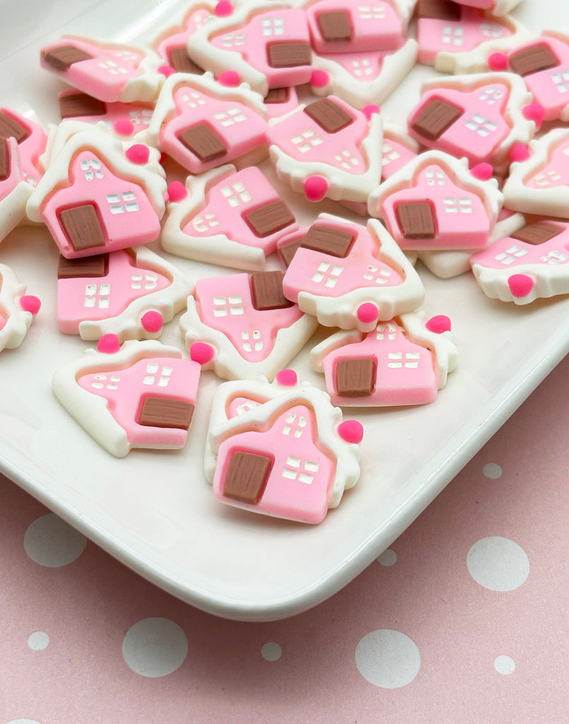 a white plate topped with pink and brown decorated cookies