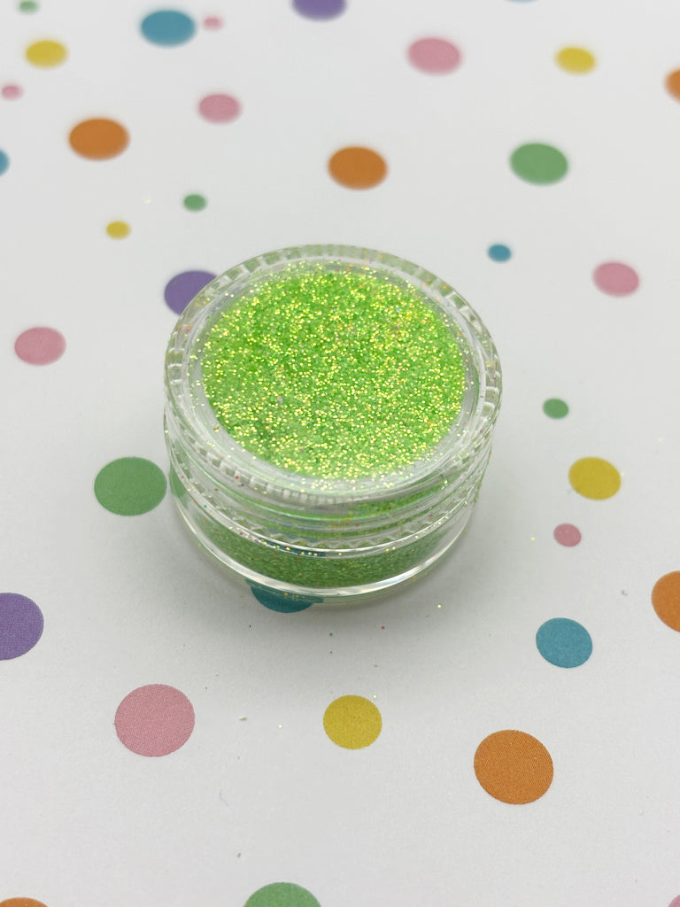a small jar of glitter sitting on a table